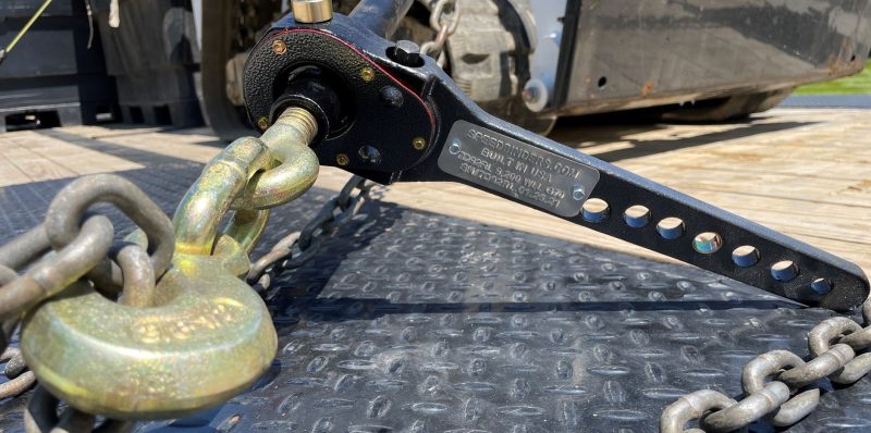 Speedbinders torque drive load binder attached to skid steer closeup